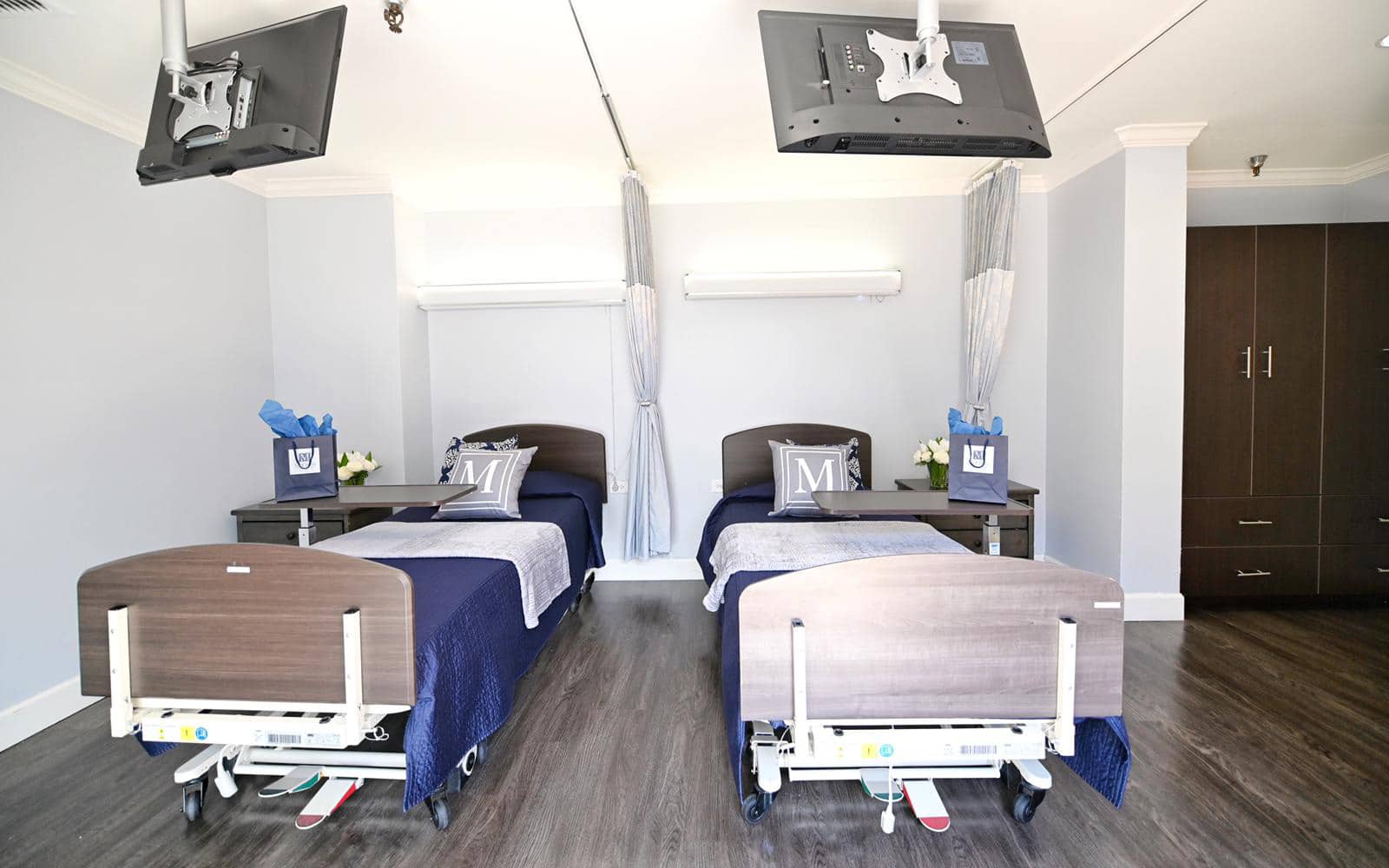 McClure Rehabilitation semi-private room with two televisions and welcome gift bags