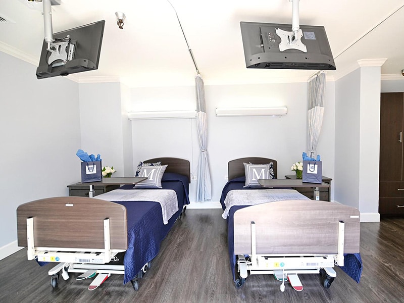 McClure Rehabilitation semi-private room with two televisions and welcome gift bags